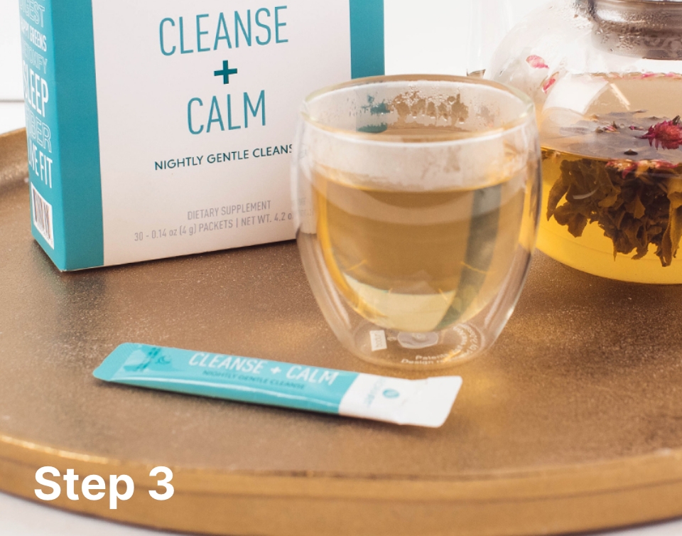 Lifestyle shot of the NeoraFit Cleanse + Calm box and sachet next to a glass mug containing the NeoraFit Cleanse + Calm product mixed with hot water.